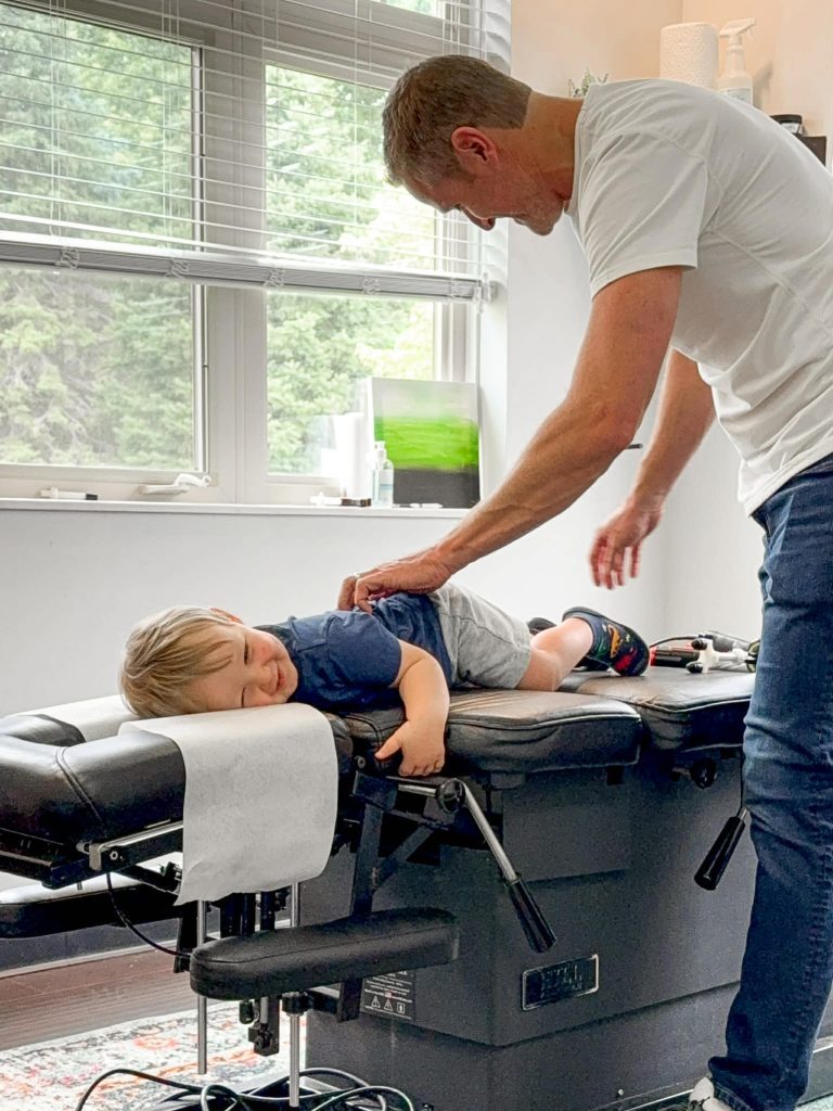 Specialist pediatric chiropractor in Ohio providing a natural wellness adjustment for a child to support nervous system health.